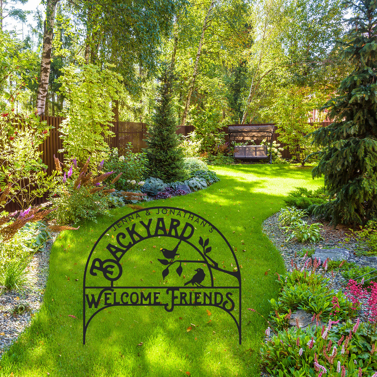 Backyard Welcome Friends metal sign staked into a manicured lawn Black